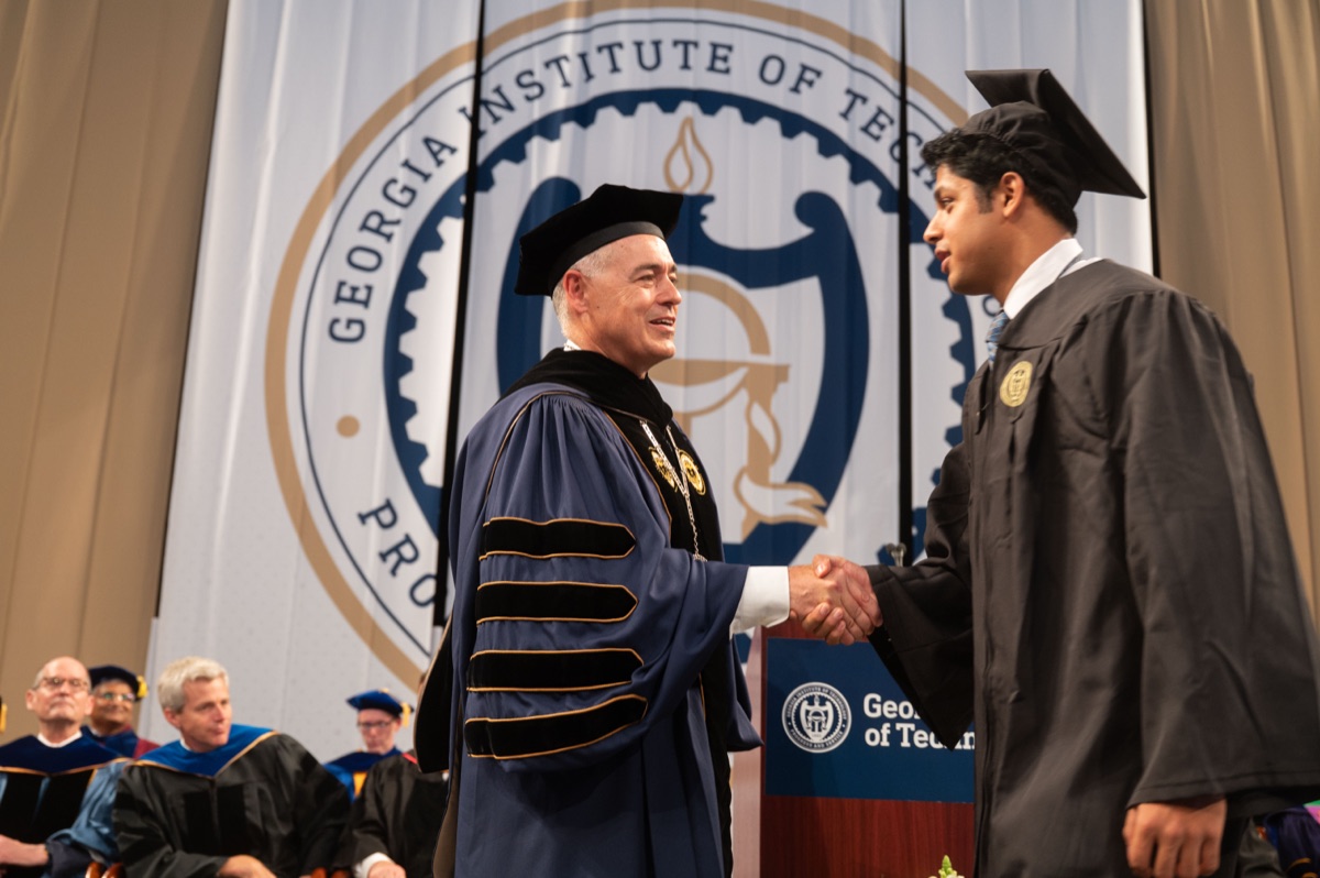 Shreyash Jha shaking hands with the Georgia Tech president at his bachelor's commencement